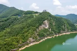 A cruise boat sailing past the cliffside Danyanggang Jando Trail