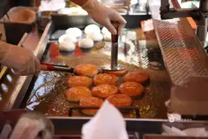 Frying Hotteok on a hot griddle
