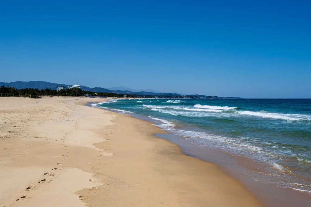 Empty sandy beach and blue sea
