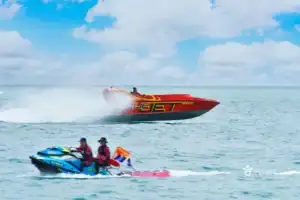 Red jet boat speeding on blue ocean